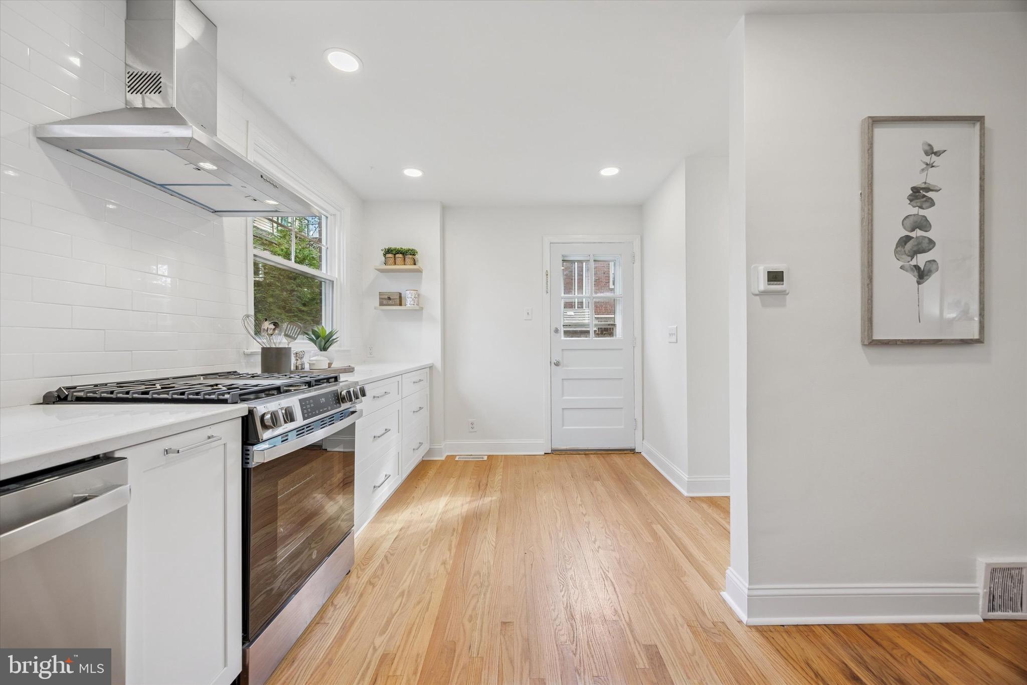 5 Llanfair Road Ardmore, PA 19003 - Photo 11 of 25 a kitchen with granite countertop a stove and a refrigerator