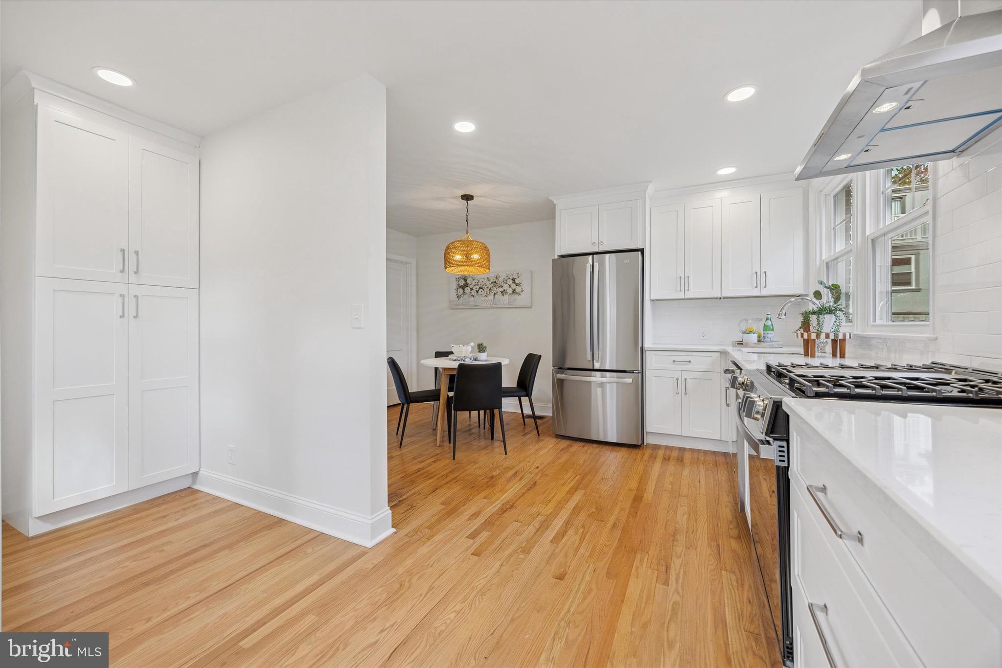 5 Llanfair Road Ardmore, PA 19003 - Photo 12 of 25 a kitchen with stainless steel appliances granite countertop a refrigerator a stove and a wooden floors