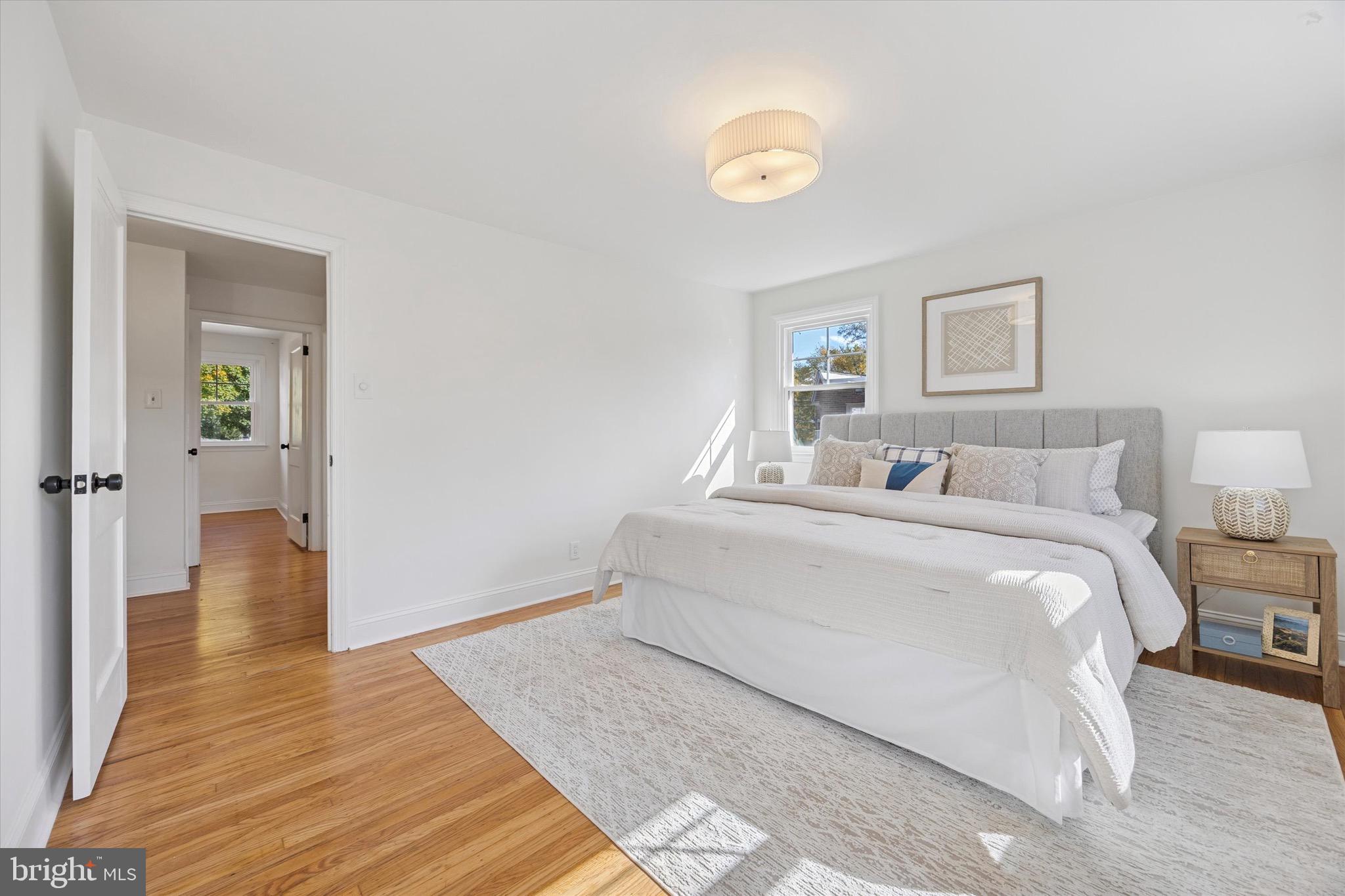 5 Llanfair Road Ardmore, PA 19003 - Photo 19 of 25 a bedroom with a bed and a painting on the wall