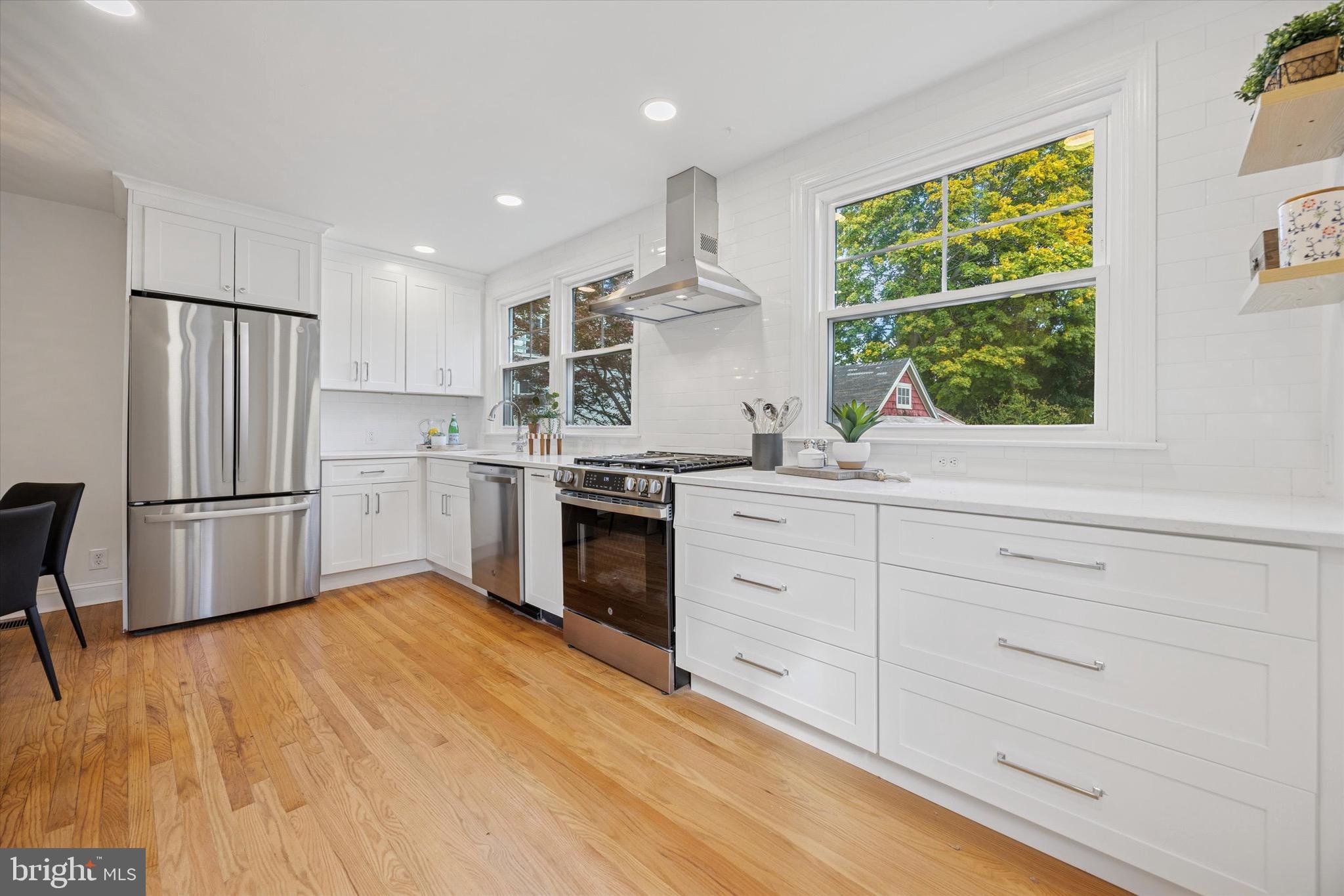 5 Llanfair Road Ardmore, PA 19003 - Photo 10 of 25 a kitchen with white cabinets and white stainless steel appliances