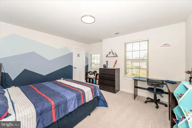 a front view of a house with a yard and a garden