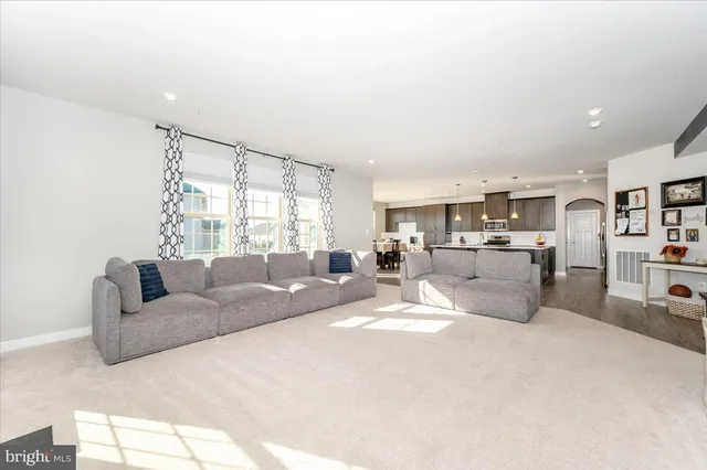 a large kitchen with stainless steel appliances kitchen island granite countertop a large counter top and a stove top oven