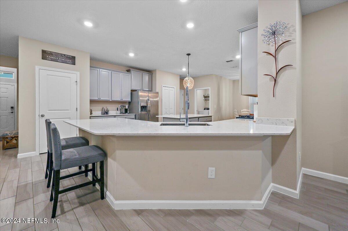 306 Brown Bear Run St. Johns, FL 32259 - Photo 4 of 24 a large kitchen with stainless steel appliances a large counter top a stove and a refrigerator