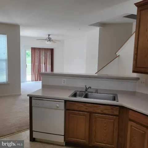 a kitchen with a sink cabinets and window