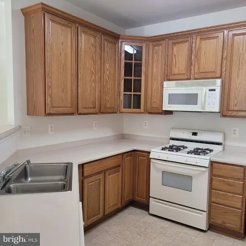 a kitchen with a stove microwave and sink