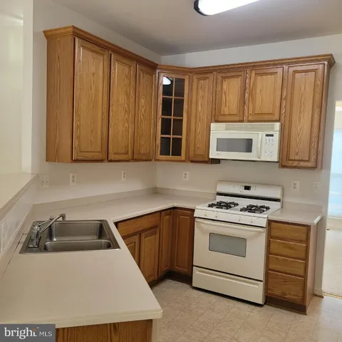 a kitchen with a stove microwave and sink