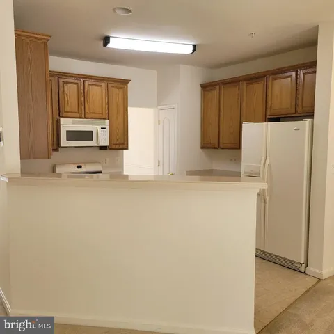 a white refrigerator freezer sitting in a kitchen