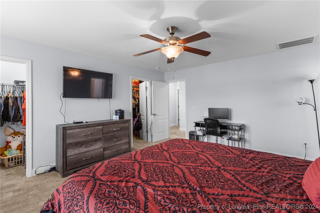 180 Pittfield Run Cameron, NC 28326 - Photo 15 of 33 a bedroom with a bed and a flat screen tv