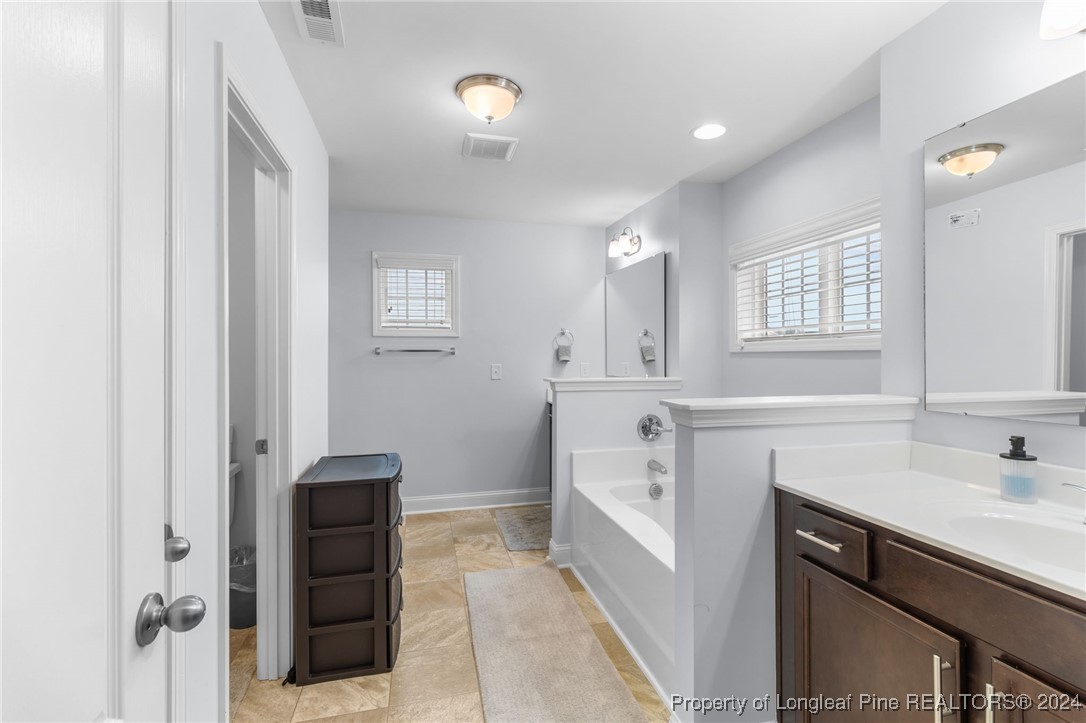 180 Pittfield Run Cameron, NC 28326 - Photo 16 of 33 a spacious bathroom with a sink double vanity and a mirror