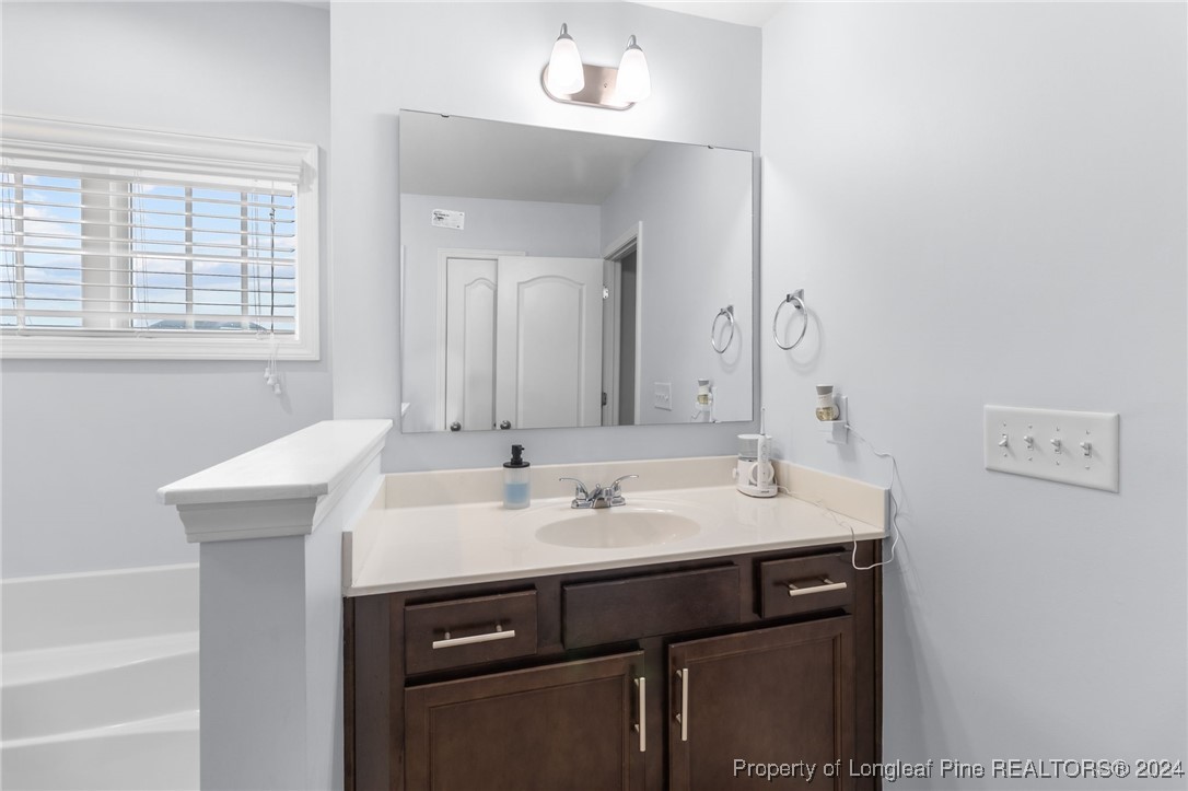 180 Pittfield Run Cameron, NC 28326 - Photo 17 of 33 a bathroom with a sink and a mirror