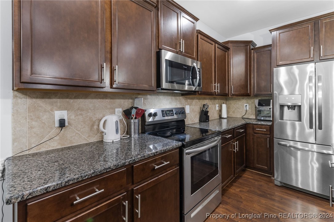 180 Pittfield Run Cameron, NC 28326 - Photo 8 of 33 a kitchen with stainless steel appliances granite countertop a sink stove and refrigerator