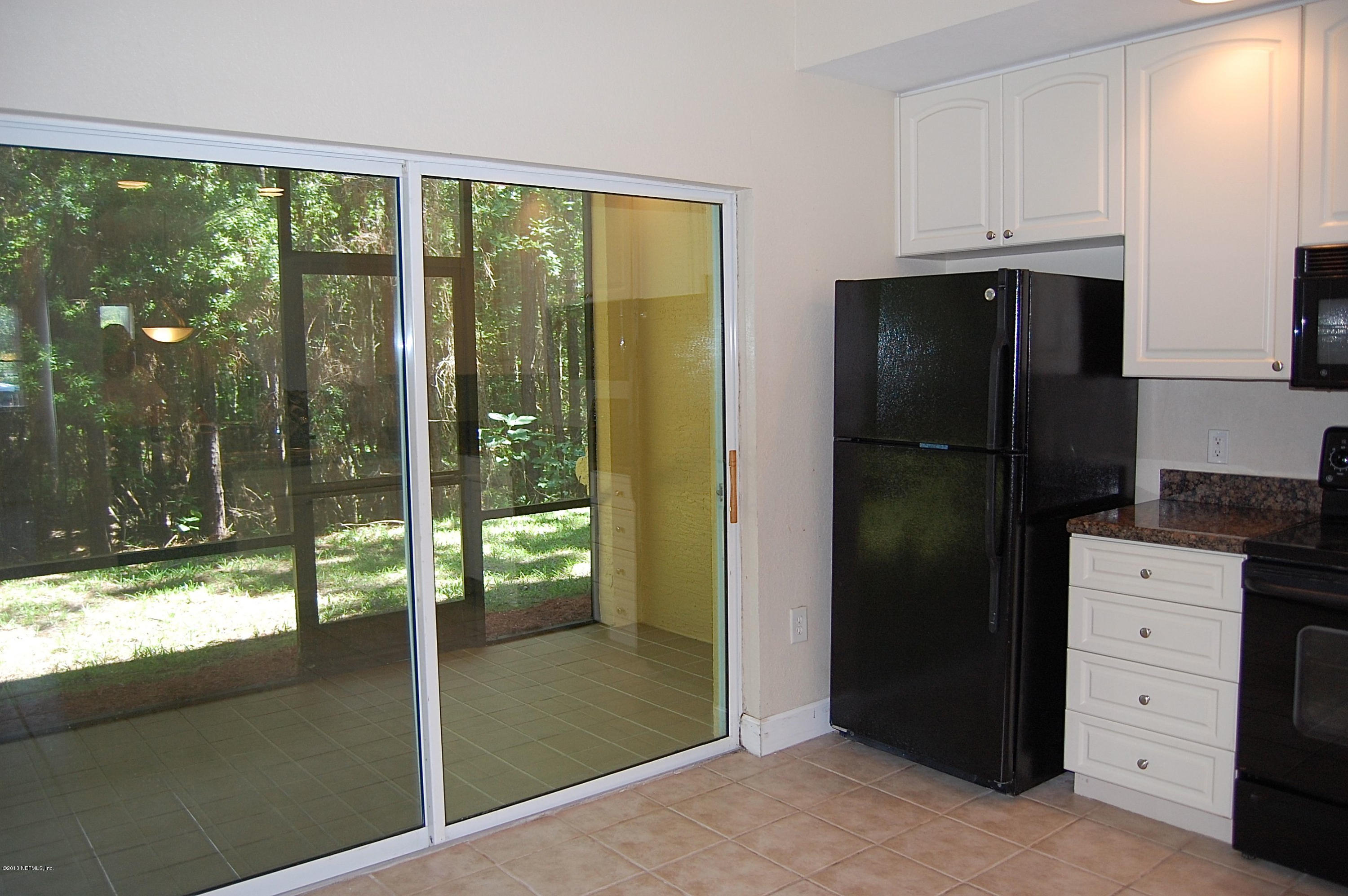 9745 Touchton Road, Unit 1004 Jacksonville, FL 32246 - Photo 19 of 23 sreened patio off of kitchen