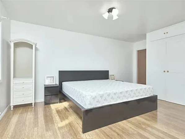 a bedroom with a bed and a dresser