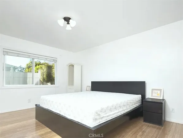 a bedroom with a bed and a large window