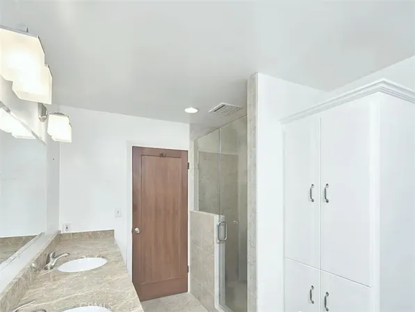 a bathroom with a shower and a sink