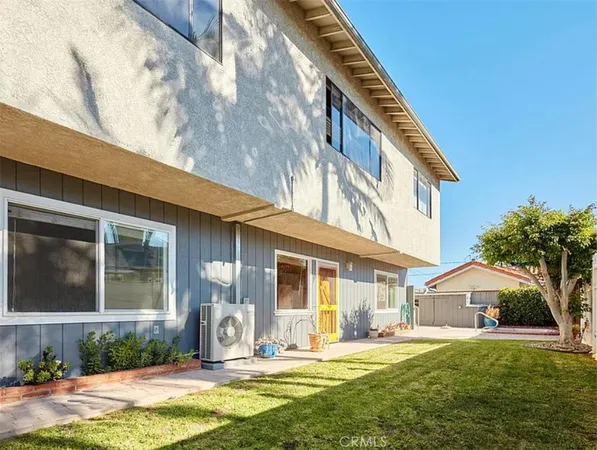 a front view of a house with a yard outdoor seating and garage