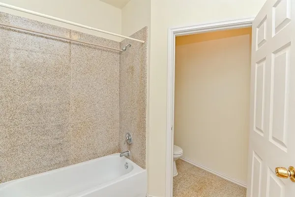 a bathroom with a shower and a bath tub