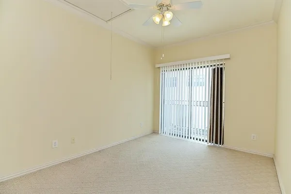 an empty room with a chandelier fan
