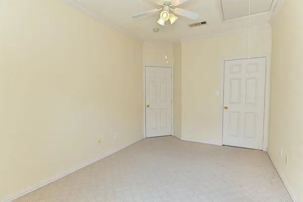an empty room with a chandelier fan