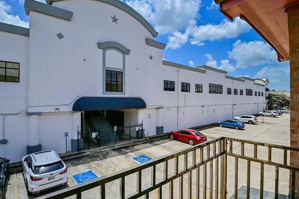 a view of a balcony with chairs and stove