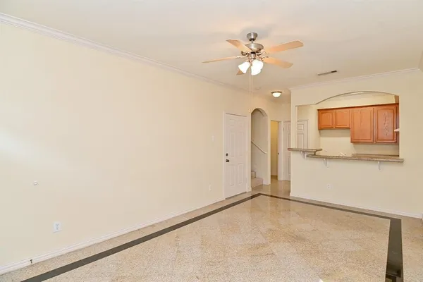 a view of a livingroom with a ceiling fan and window