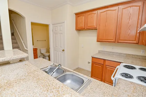 a kitchen with a sink and a refrigerator
