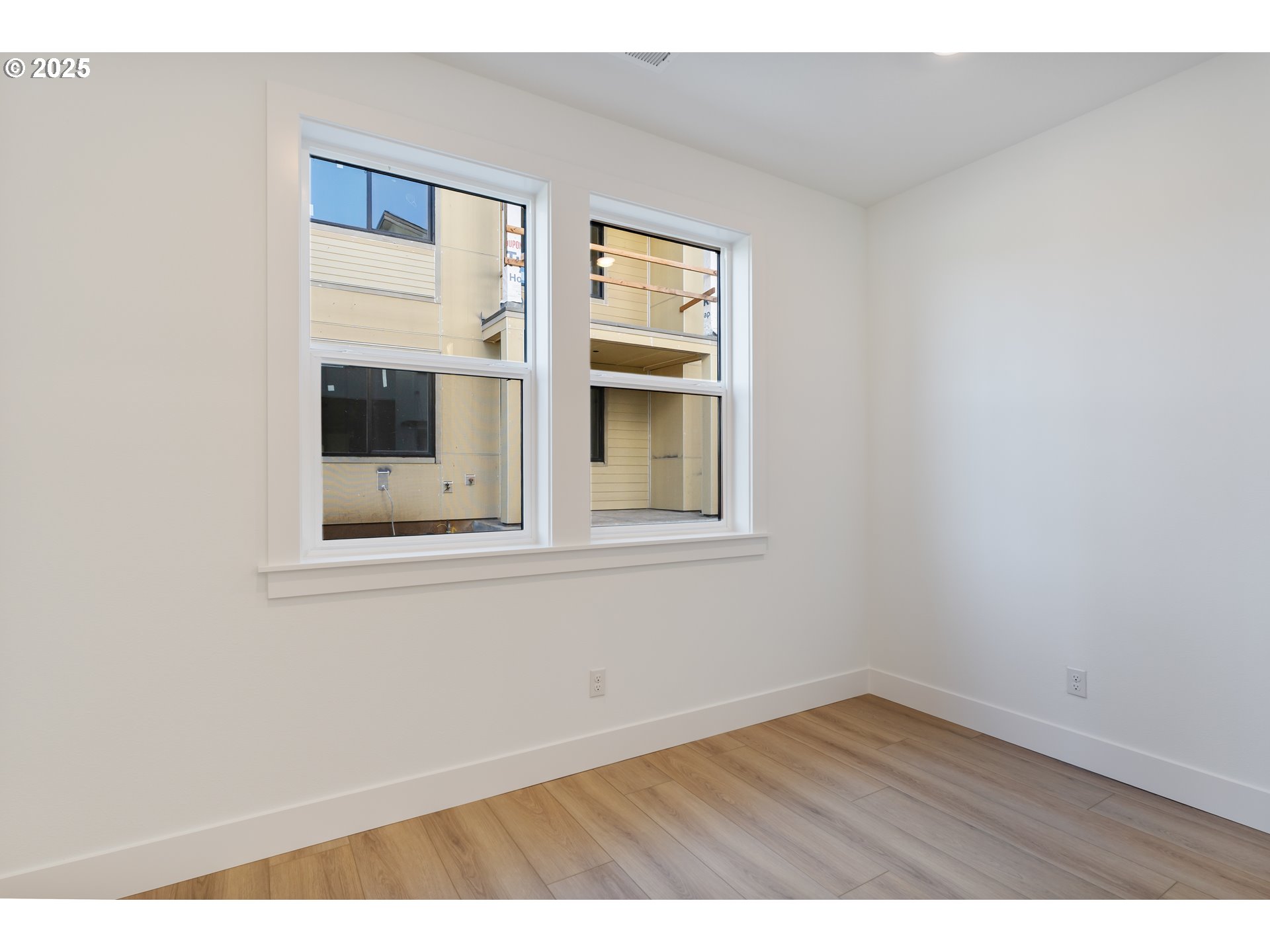 6483 Northwest Olympic Lane, Unit L28 Camas, WA 98607 - Photo 13 of 42 a view of empty room with wooden floor and fan