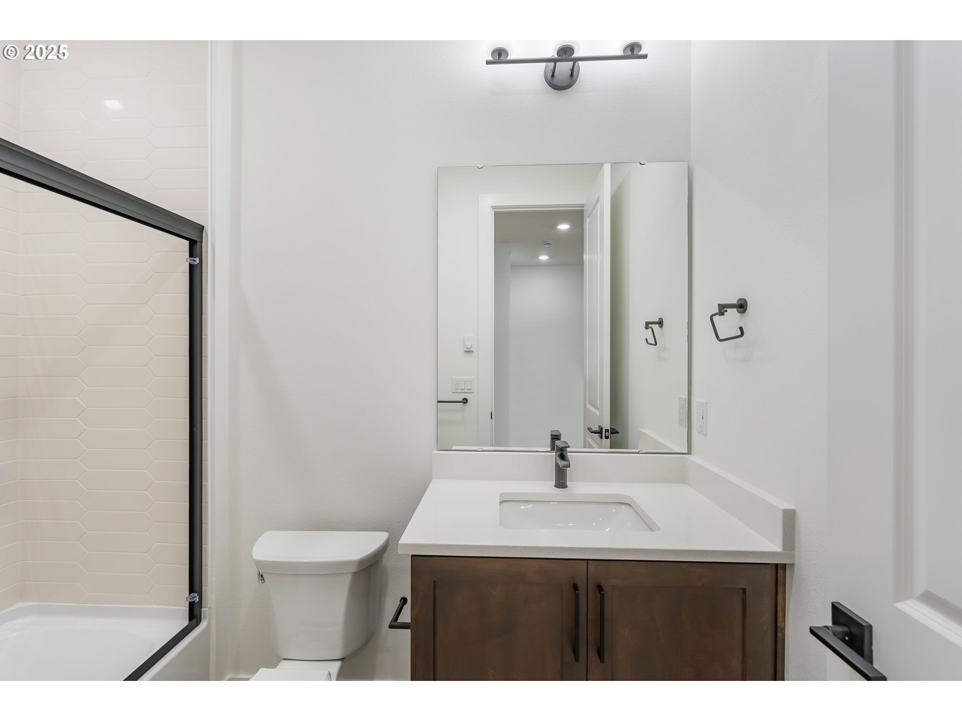 6483 Northwest Olympic Lane, Unit L28 Camas, WA 98607 - Photo 14 of 42 a bathroom with a sink a toilet and a mirror