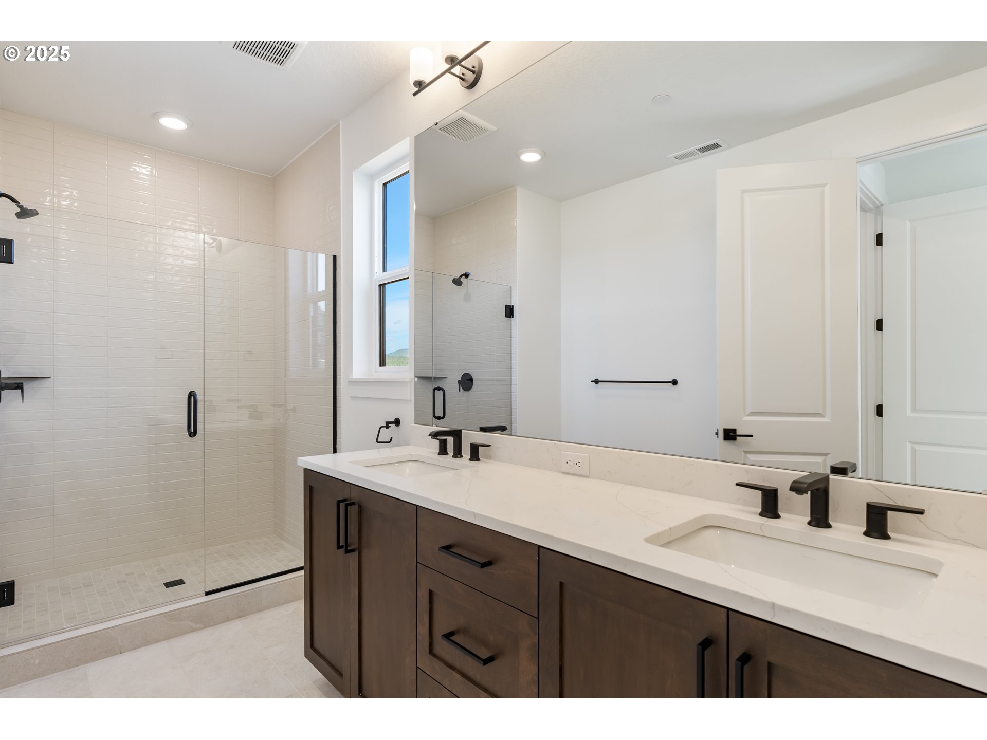 6483 Northwest Olympic Lane, Unit L28 Camas, WA 98607 - Photo 18 of 42 a bathroom with a sink double vanity and a mirror