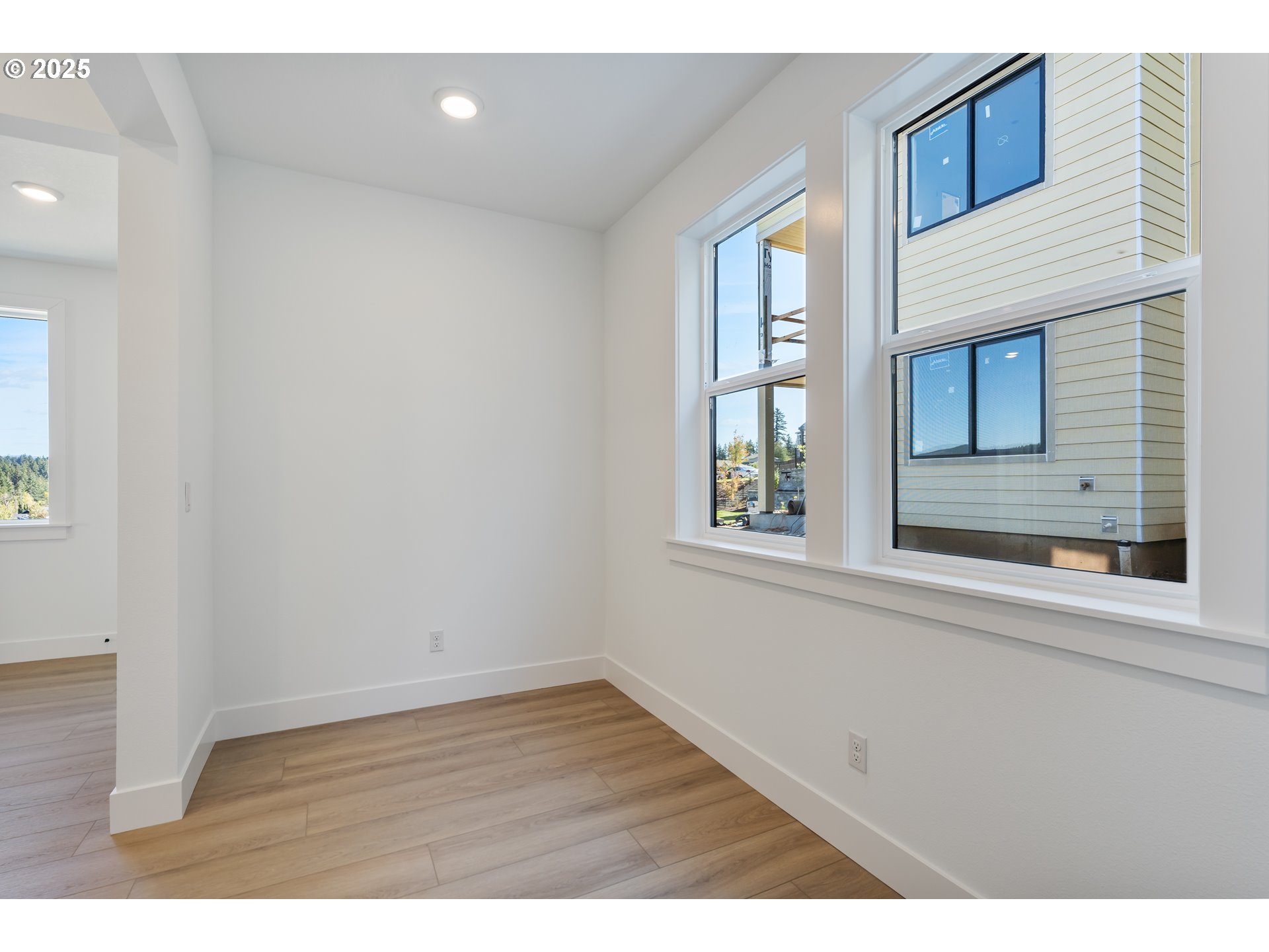 6483 Northwest Olympic Lane, Unit L28 Camas, WA 98607 - Photo 24 of 42 a view of an empty room with wooden floor and a window