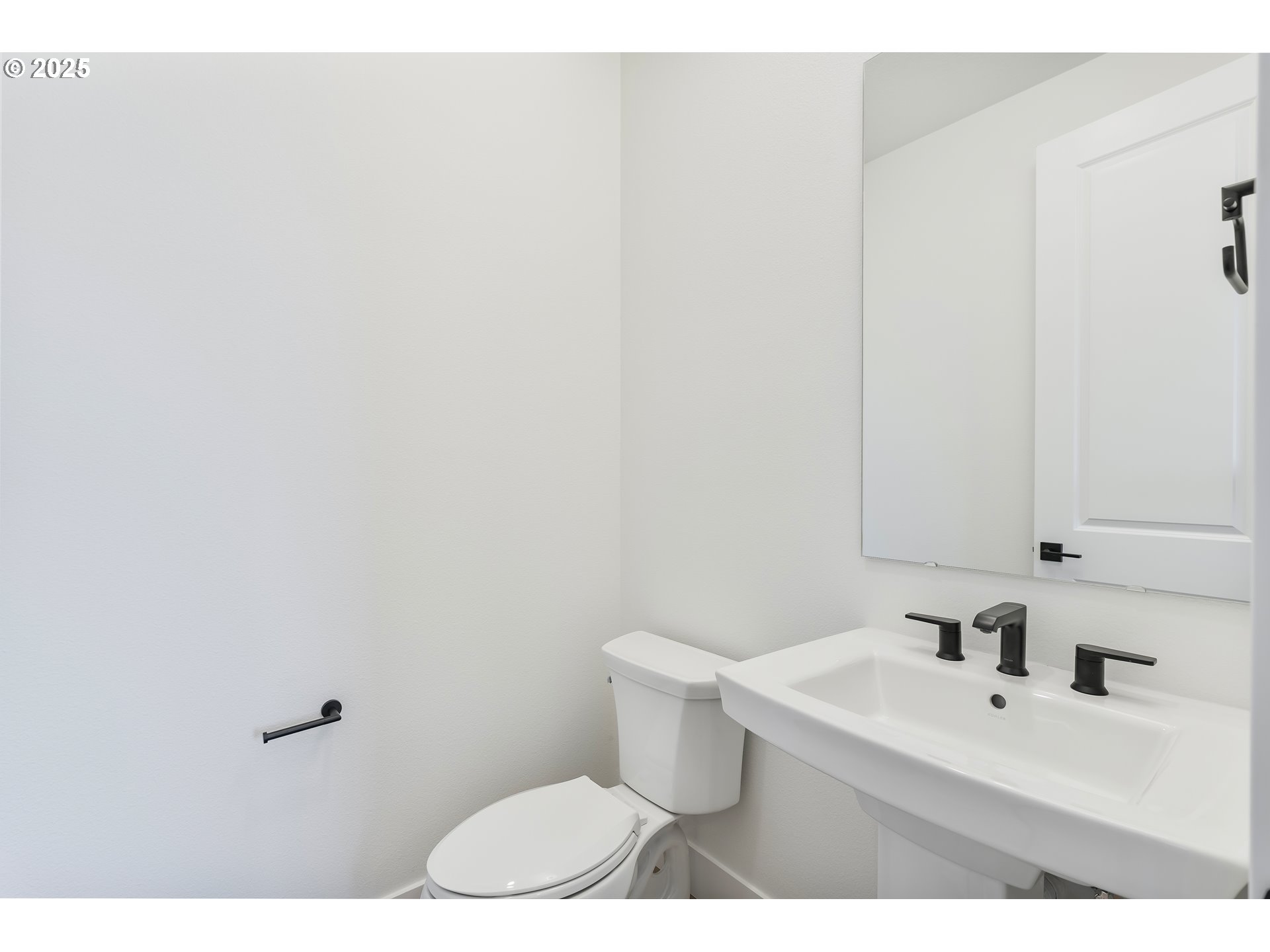 6483 Northwest Olympic Lane, Unit L28 Camas, WA 98607 - Photo 32 of 42 a bathroom with a sink a toilet and mirror