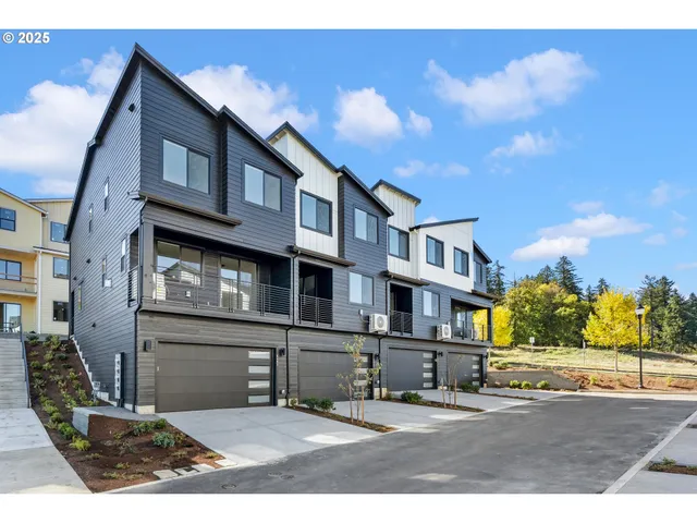 a front view of a residential apartment building with a yard