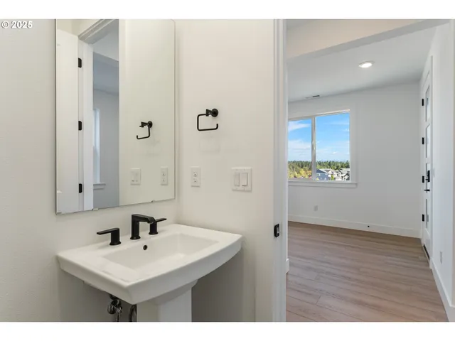 a view of a kitchen with a sink and a refrigerator