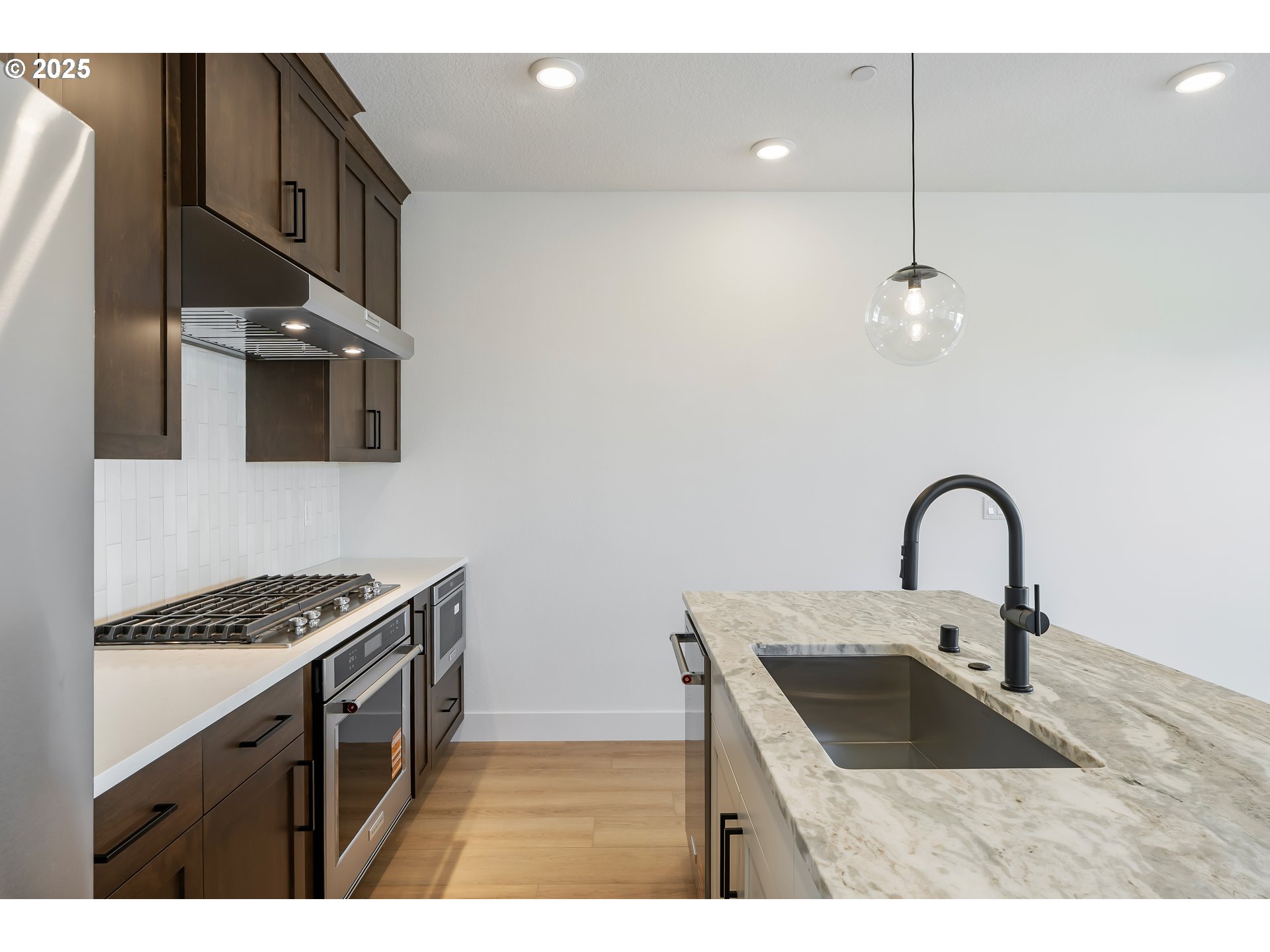 6483 Northwest Olympic Lane, Unit L28 Camas, WA 98607 - Photo 41 of 42 a kitchen with a sink cabinets and appliances