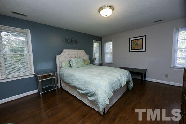 7108 Kinross Drive Raleigh, NC 27613 - Photo 14 of 25 a bedroom with a bed and a window