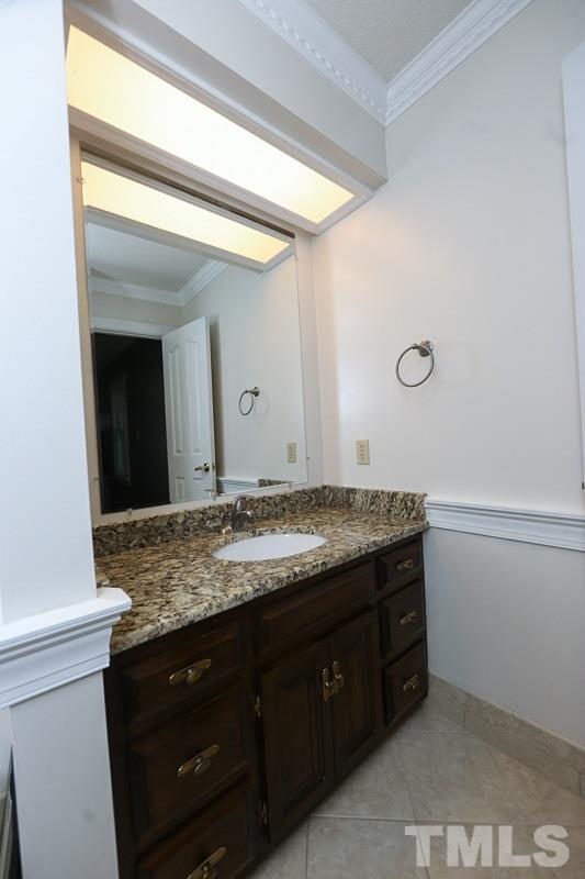 7108 Kinross Drive Raleigh, NC 27613 - Photo 15 of 25 a bathroom with a granite countertop sink and a mirror