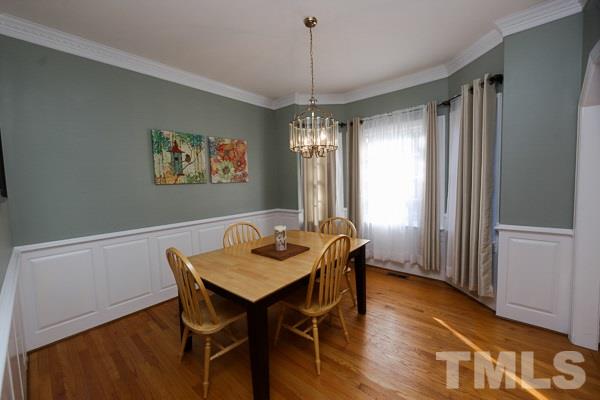 7108 Kinross Drive Raleigh, NC 27613 - Photo 3 of 25 a view of a dining room with furniture window and wooden floor
