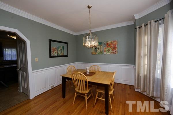 7108 Kinross Drive Raleigh, NC 27613 - Photo 4 of 25 a view of a dining room with furniture window and wooden floor