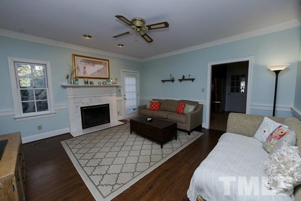 7108 Kinross Drive Raleigh, NC 27613 - Photo 5 of 25 a living room with furniture fireplace and a flat screen tv