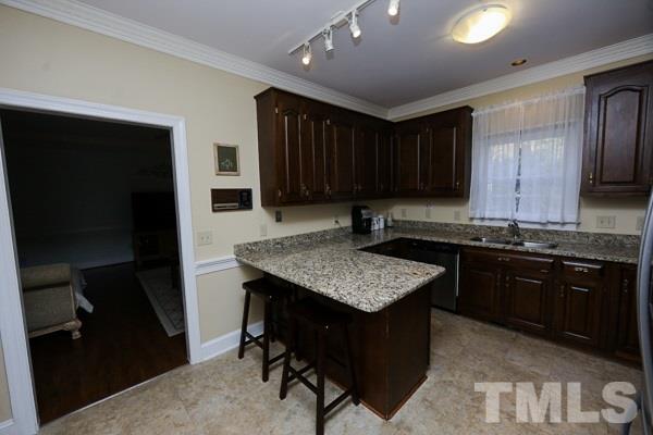 7108 Kinross Drive Raleigh, NC 27613 - Photo 8 of 25 a kitchen with a sink refrigerator and cabinets