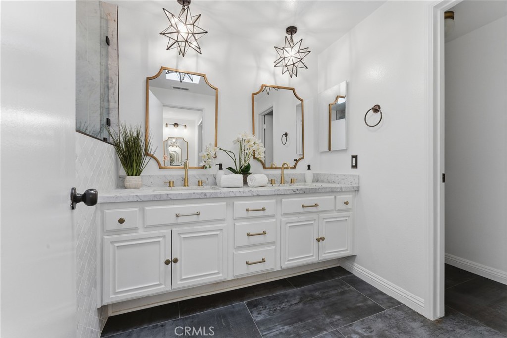 8180 Manitoba Street, Unit 330 Playa del Rey, CA 90293 - Photo 16 of 31 a bathroom with double vanity sinks a vanity a lamp and a mirror