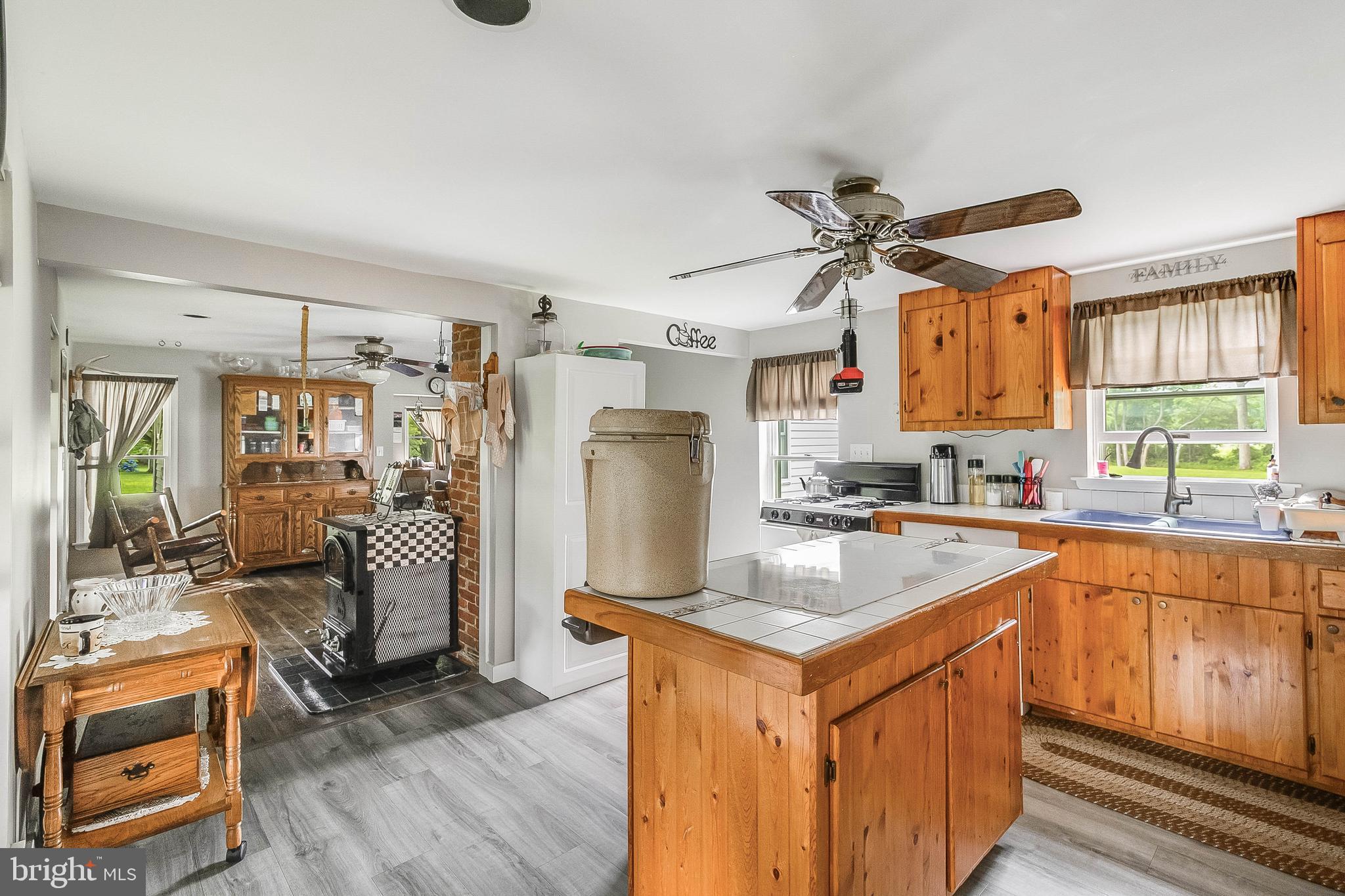 5634 Pearsons Corner Road Dover, DE 19904 - Photo 11 of 40 a kitchen with stainless steel appliances granite countertop a refrigerator a sink dishwasher a stove and white countertops with wooden floor
