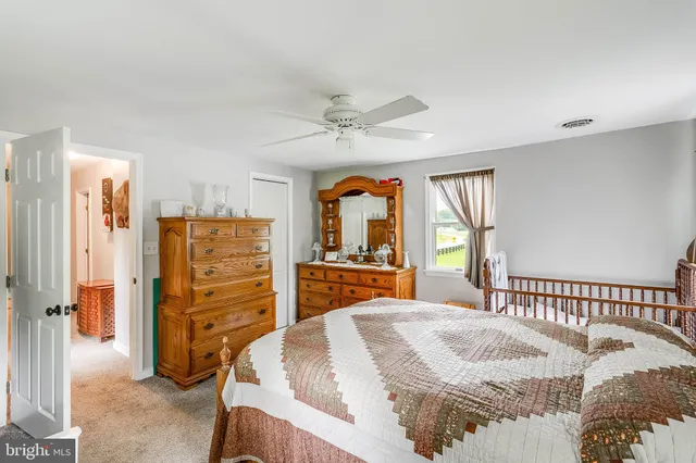 a bedroom with a bed and a large mirror