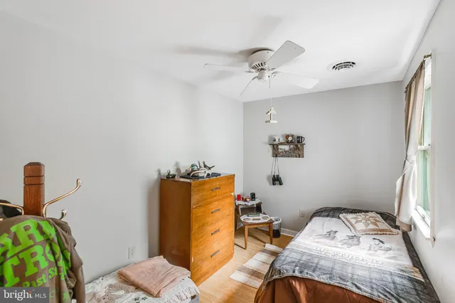 a bed sitting in a bedroom next to a window