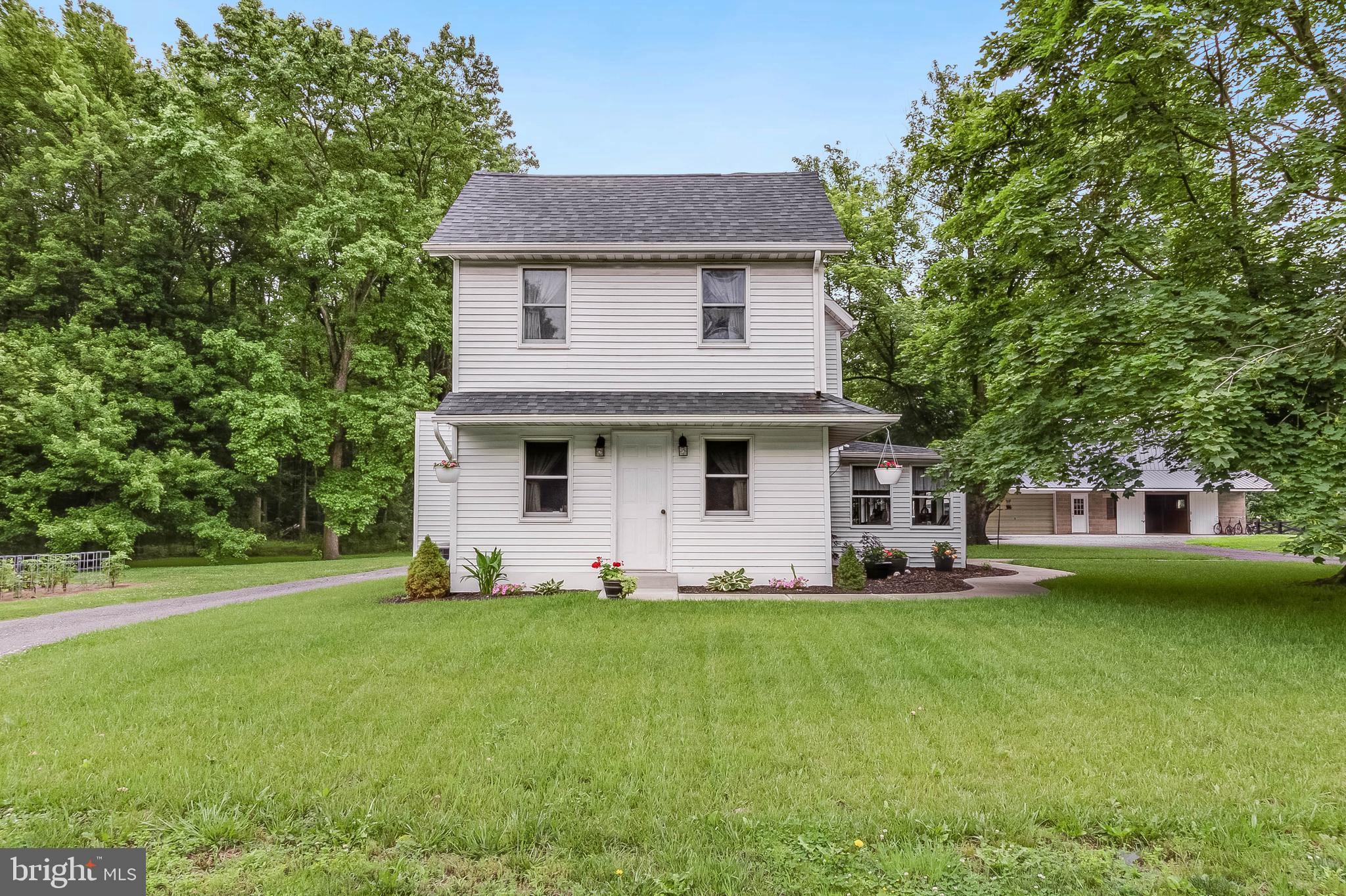 5634 Pearsons Corner Road Dover, DE 19904 - Photo 2 of 40 a front view of a house with a yard and trees