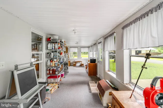 a view of a livingroom with workspace and a window