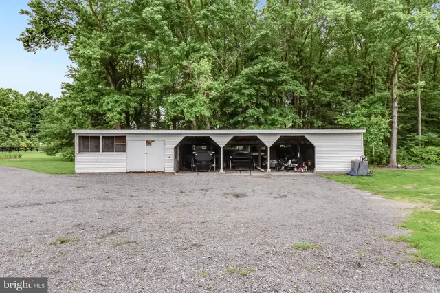 an aerial view of a house with a garden and lake view
