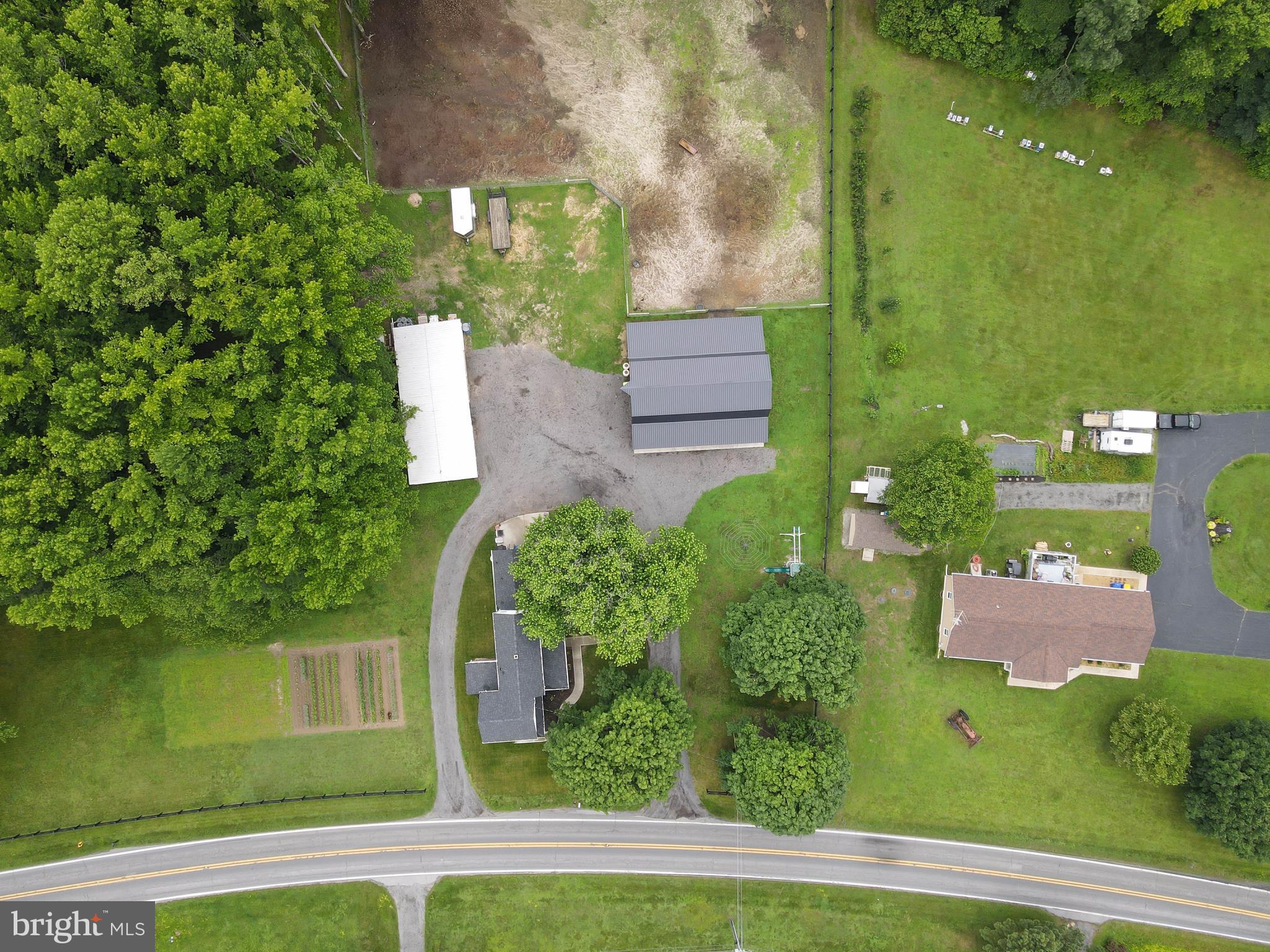 5634 Pearsons Corner Road Dover, DE 19904 - Photo 38 of 40 an aerial view of a house with a garden and lake view