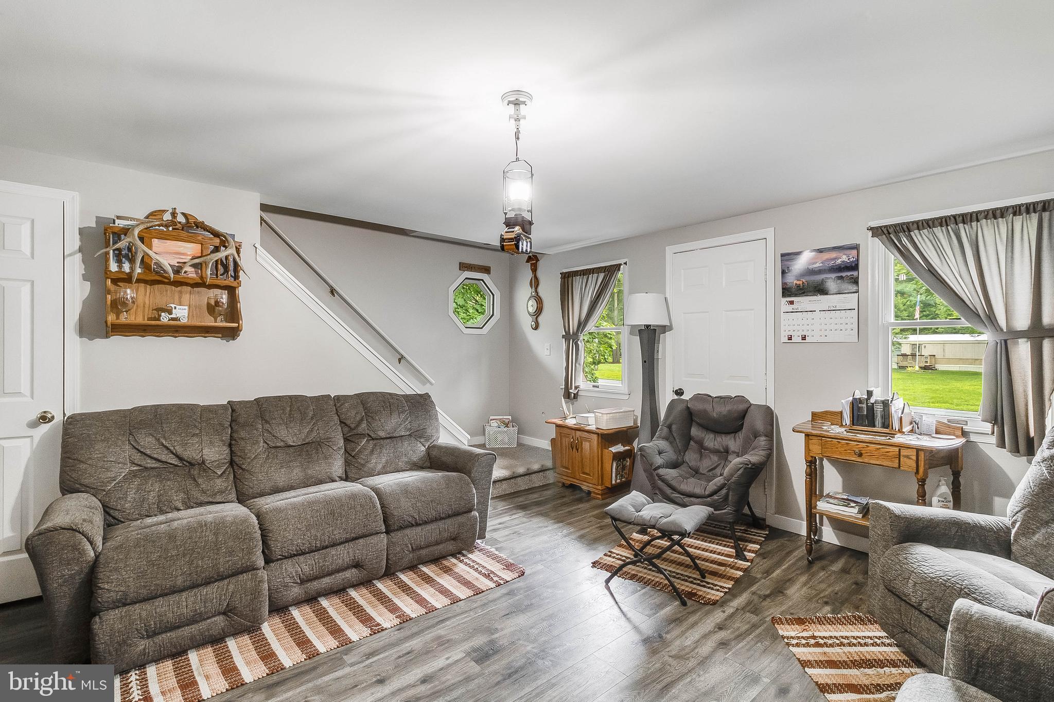 5634 Pearsons Corner Road Dover, DE 19904 - Photo 4 of 40 a living room with furniture a window and a chandelier