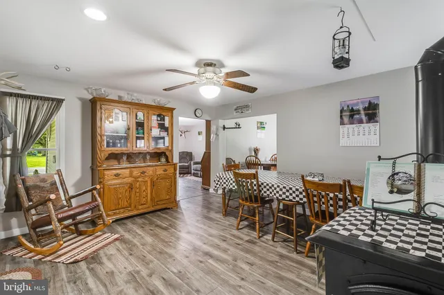a living room with furniture a dining table and with wooden floor